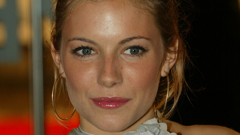 Sienna Miller looking off to the side