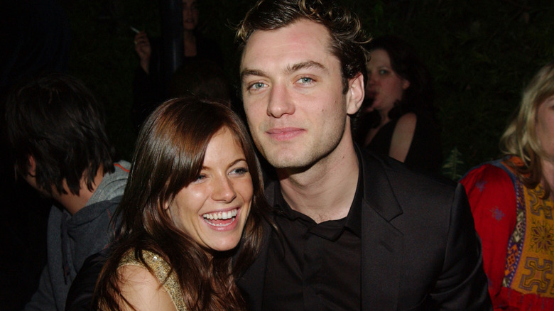 Sienna Miller and Jude Law posing