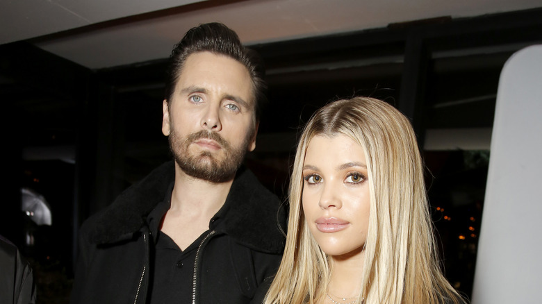 Sofia Richie and Scott Disick posing 