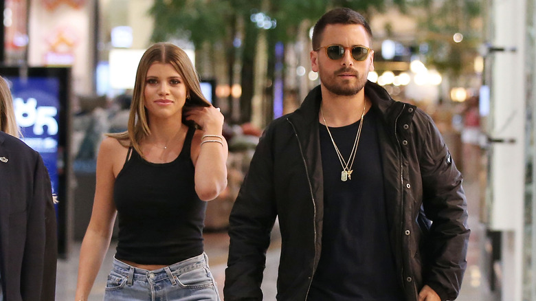 Sofia Richie and Scott Disick walking  