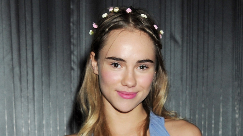 Suki Waterhouse in a blue dress with a flower crown