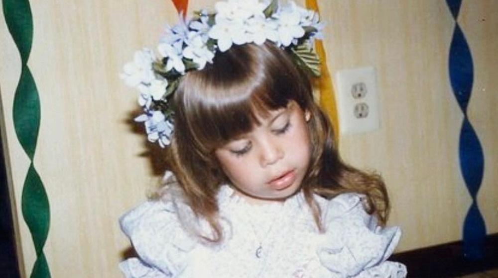 Young Tara Lipinski wearing a flower crown