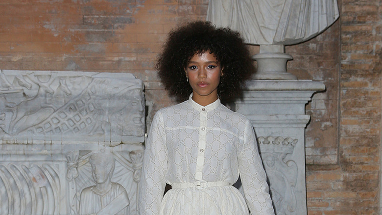 Taylor Russell posing in front of a statue