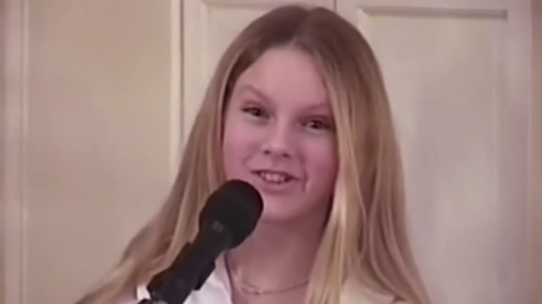 A young Taylor Swift with microphone