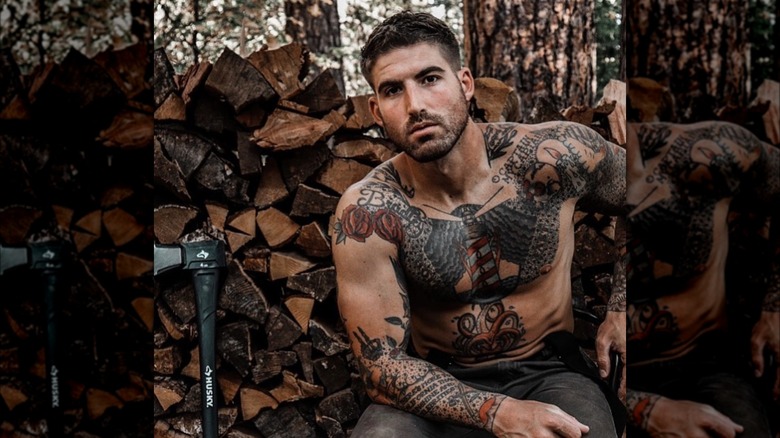 Thoren Bradley posing in front of a woodpile