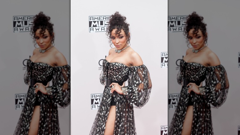 Tinashe posing on step-and-repeat