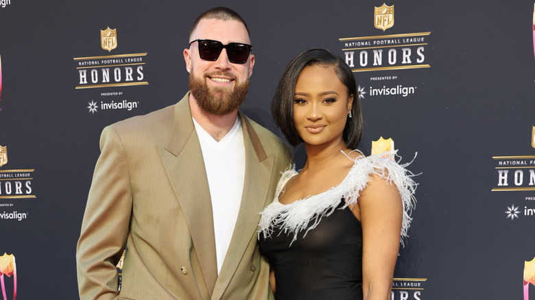 Travis Kelce and Kayla Nicole posing on a red carpet