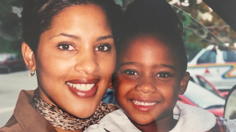 A young Kayla Nicole smiling with her mother smiling