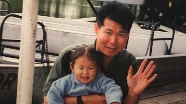 Young Chloe Kim with dad waving