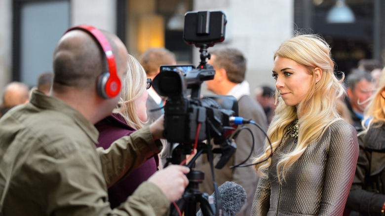 Vanessa Kirby being interviewed by reporter in front of camera crew on red carpet