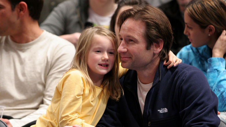 Young West and David Duchovny seated and smiling