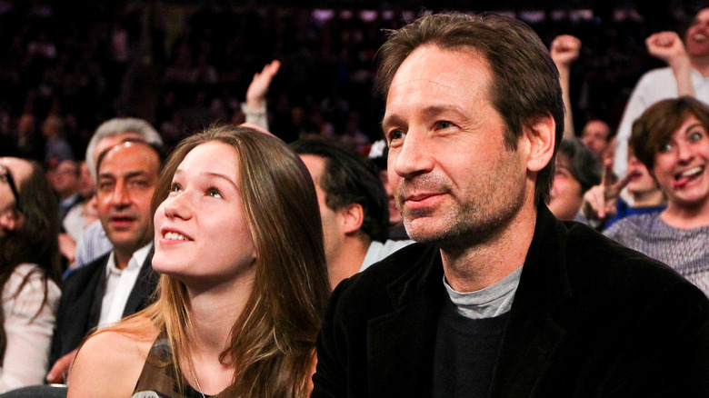 West and David Duchovny seated and smiling