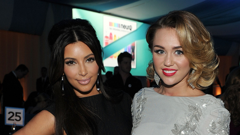 Miley Cyrus and Kim Kardashian pose for a photo. 