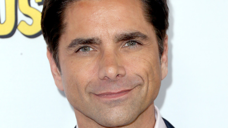 John Stamos smiling on the red carpet