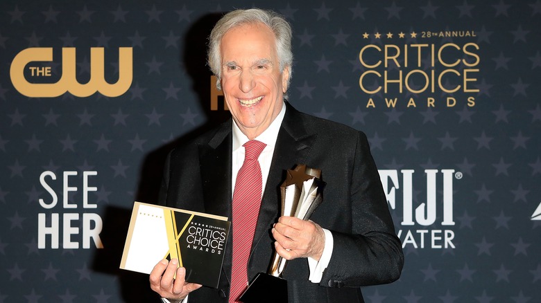 Henry Winkler holding a Critics Choice Award