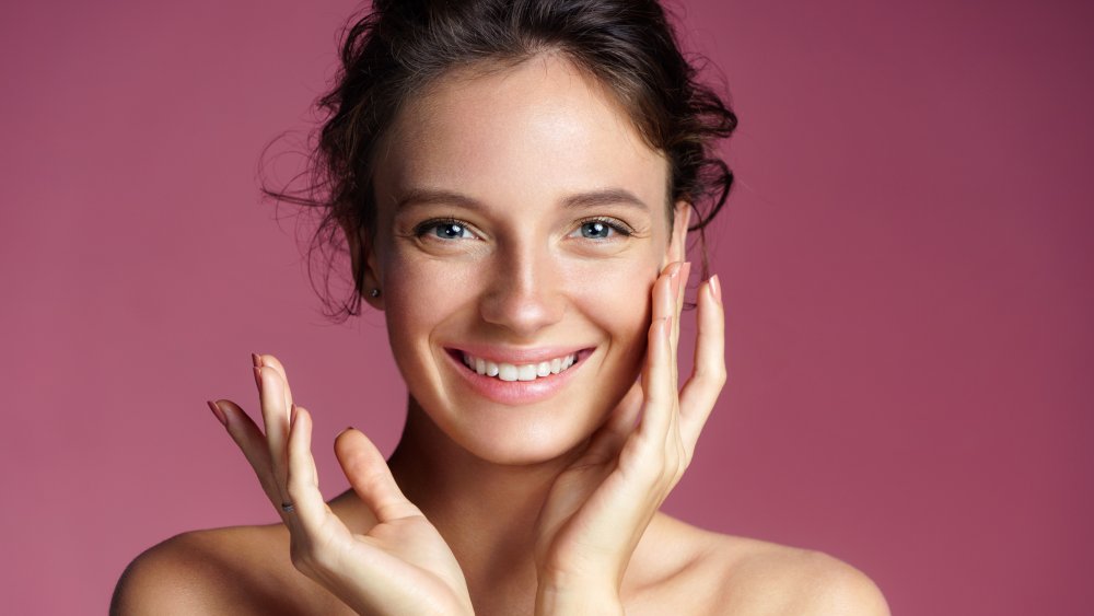 Woman putting moisturizer on her face