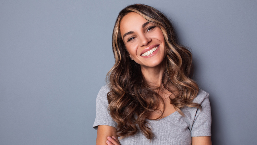 Woman with long wavy hair smiling