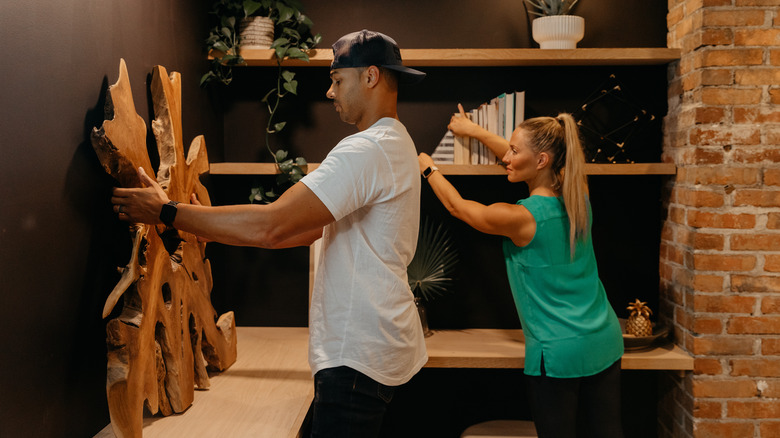 Brooke and Brice Gilliam arranging wall decor