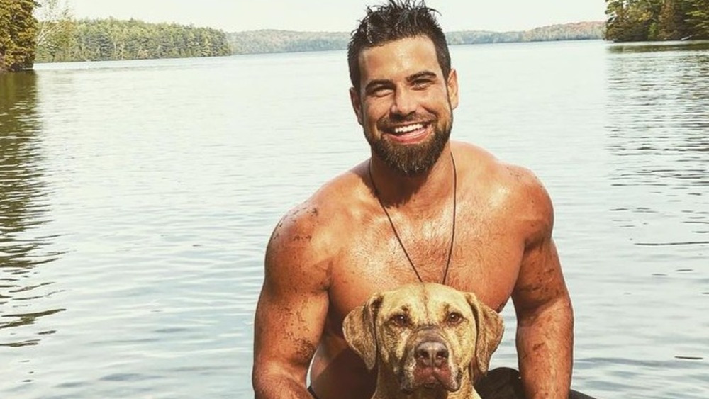 Blake Moynes and dog in lake