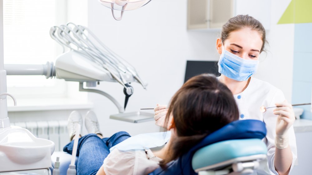 Dentist checking patient