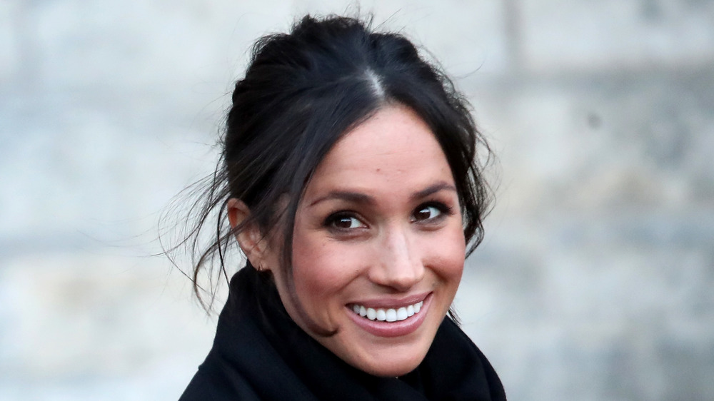 Meghan Markle smiles for photographers 