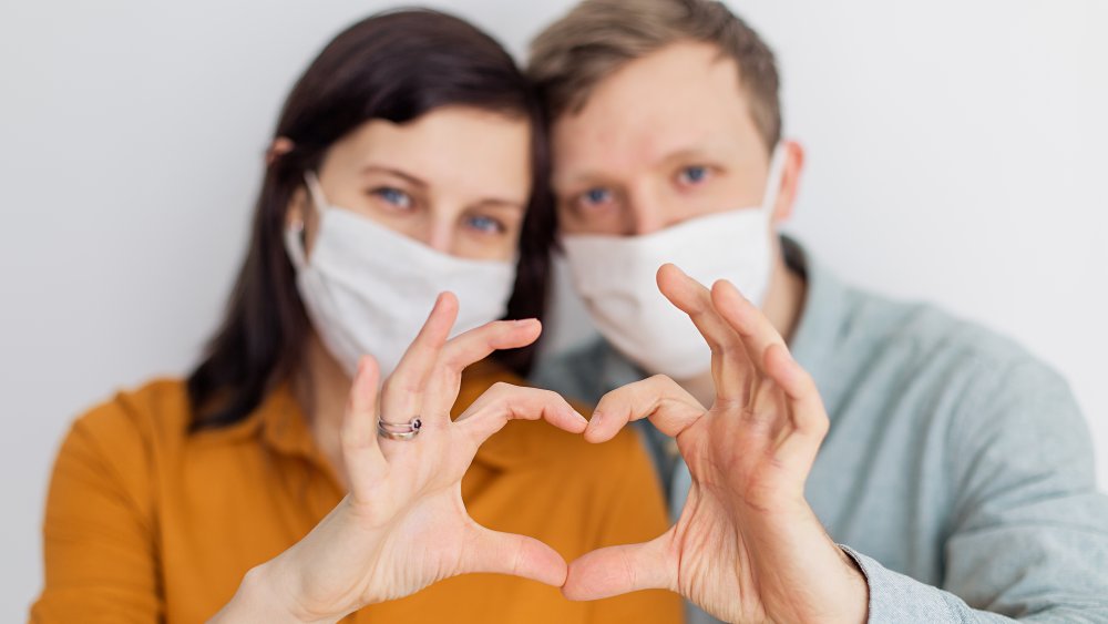 Gen Z roommates making hearts with hands