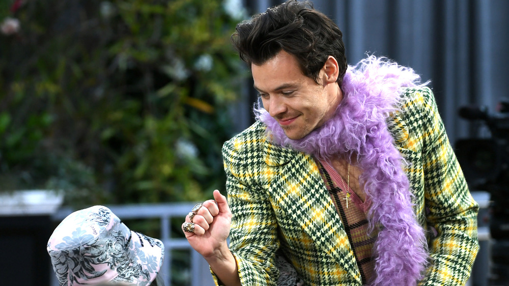 Harry Styles in jacket and boa