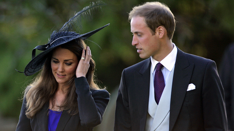 Kate Middleton and Prince William walking together at a wedding