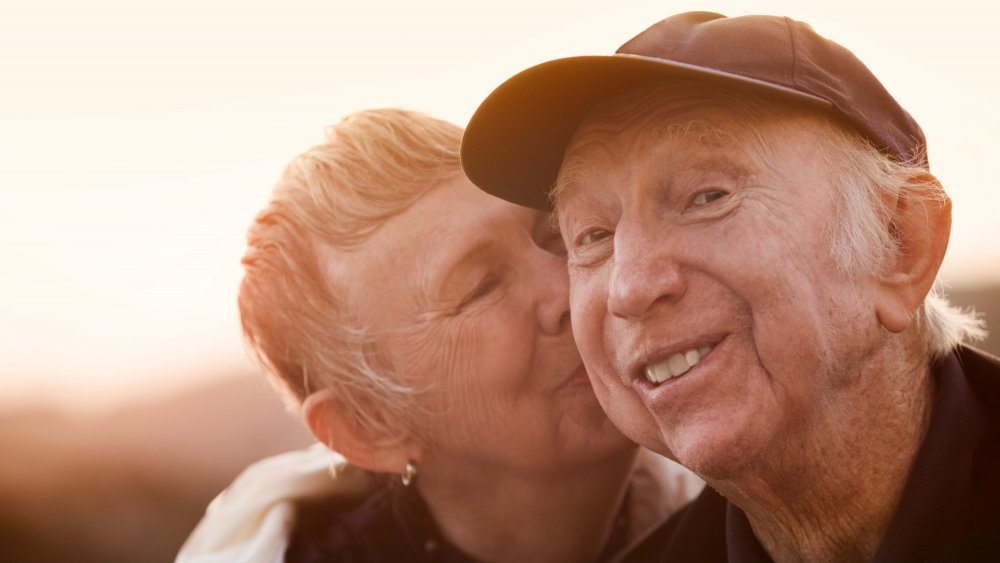 Happy man being kissed by woman 