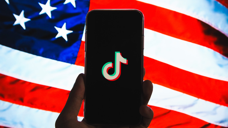 TikTok on a phone against the American flag