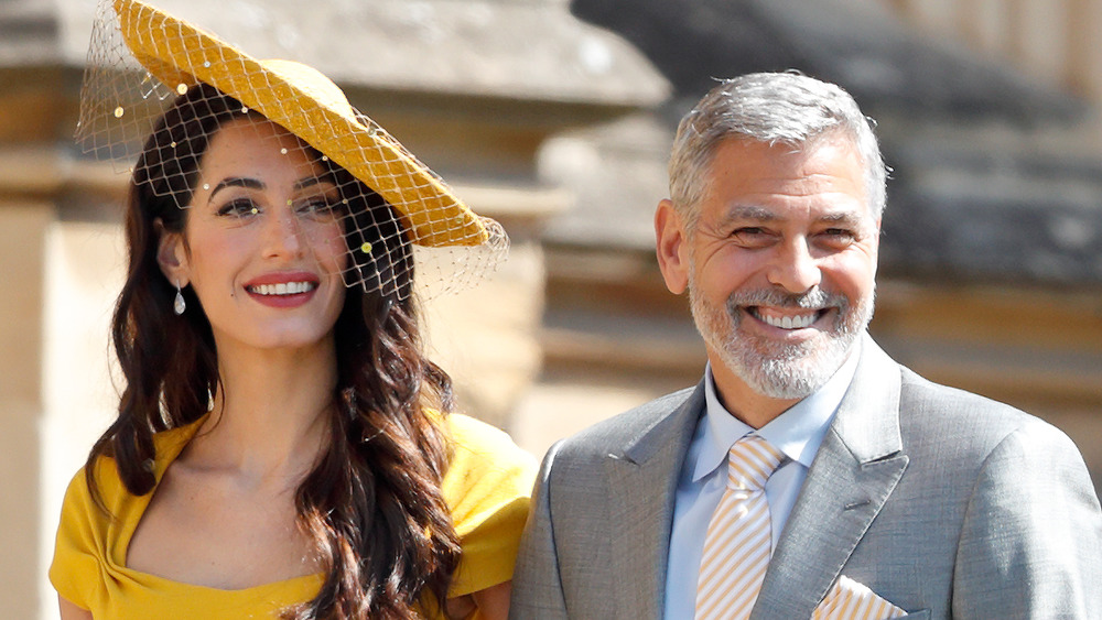 George and Amal Clooney yellow hat