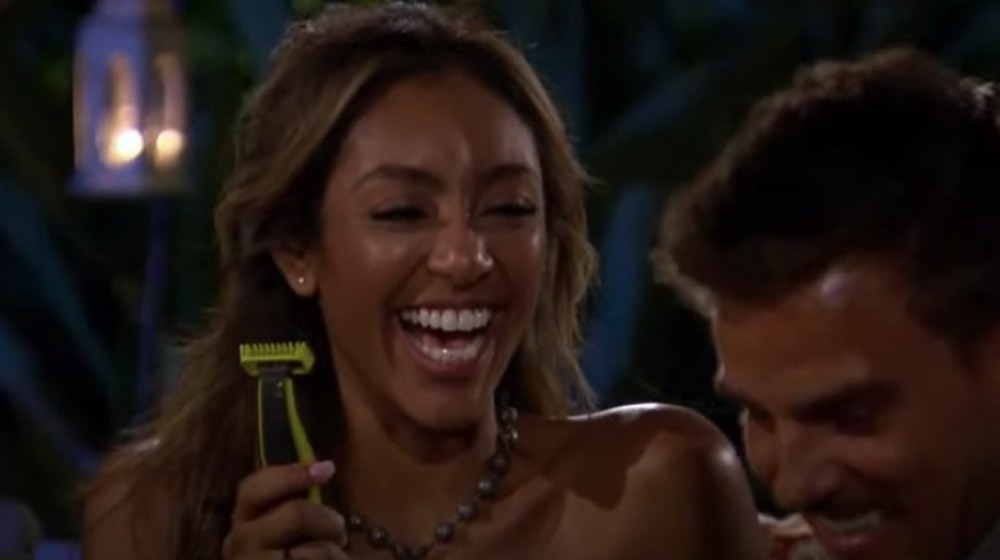 Tayshia Adams holds razor with Noah