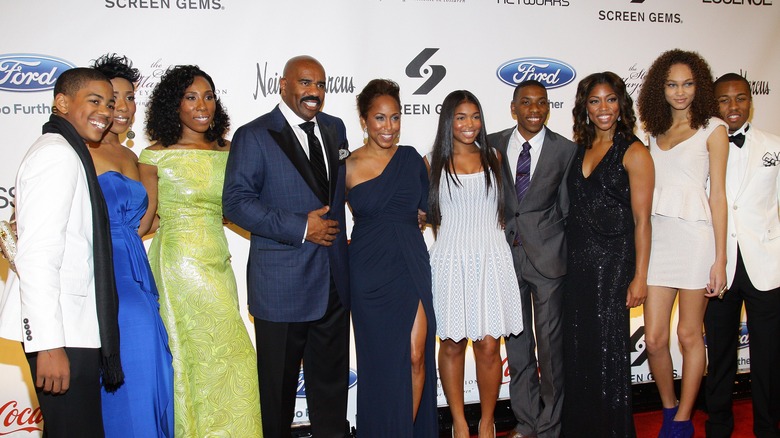 steve harvey photographed with his blended family on the red carpet
