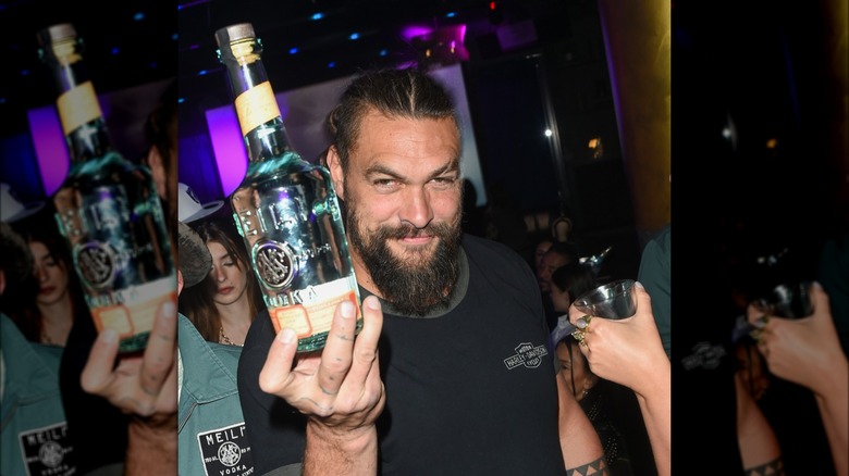 Jason Momoa holding Meili Vodka