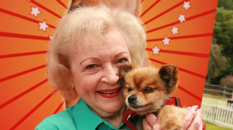 Betty White holding a puppy