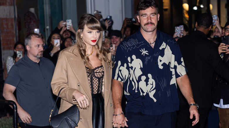 Taylor Swift and Travis Kelce holding hands