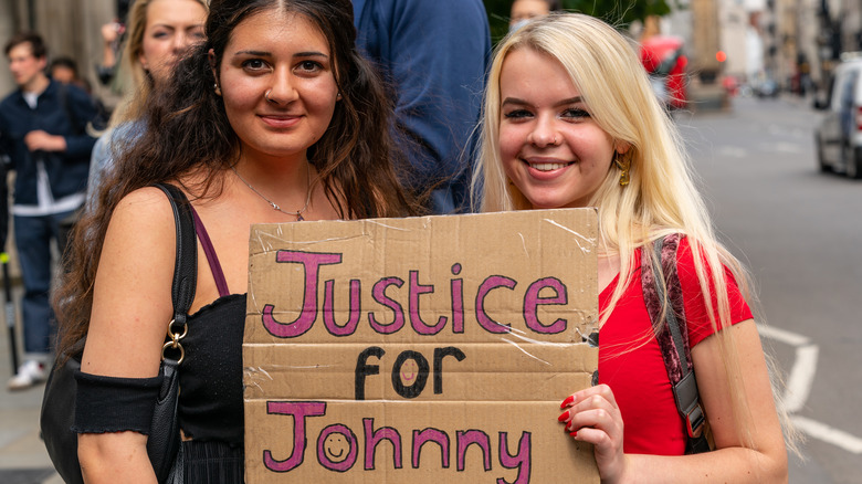 protestors for Johnny Depp holding sign