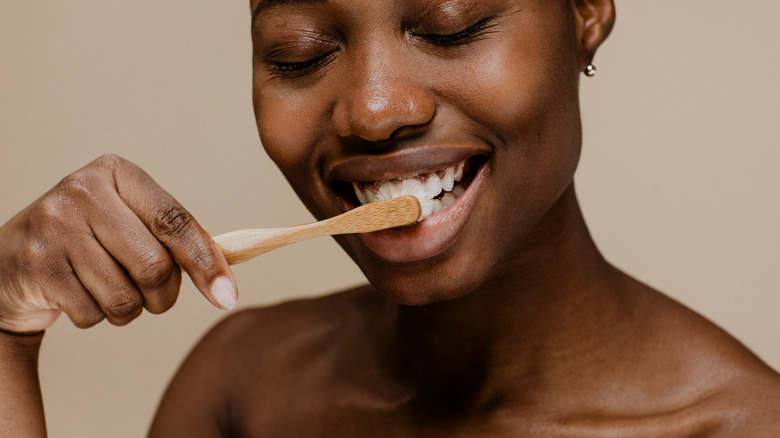 A woman brushing her teeth 