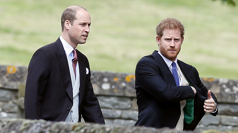 Prince William and Prince Harry walking in suits