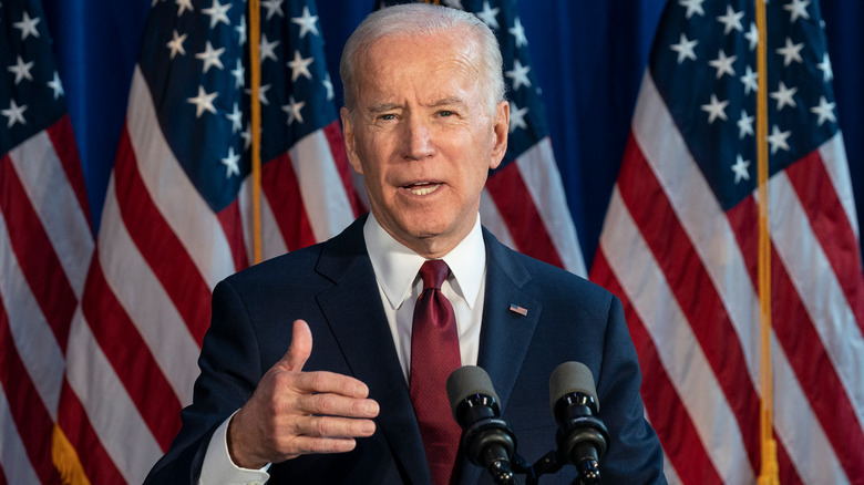 President Joe Biden speaking behind podium