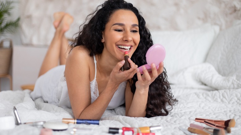 Woman applying lipstick