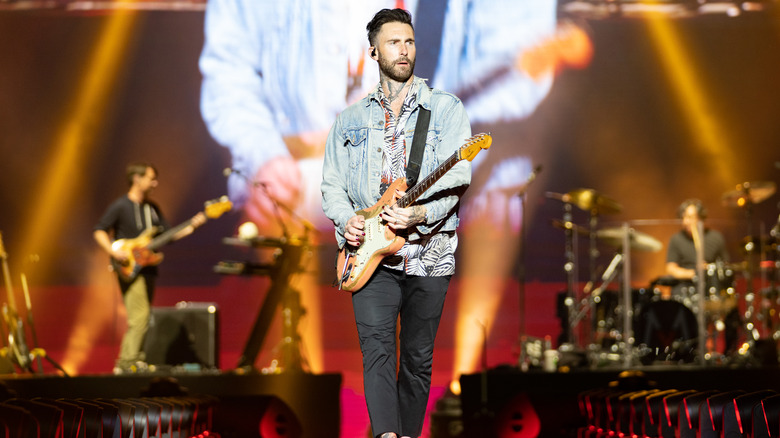 Adam Levine playing guitar