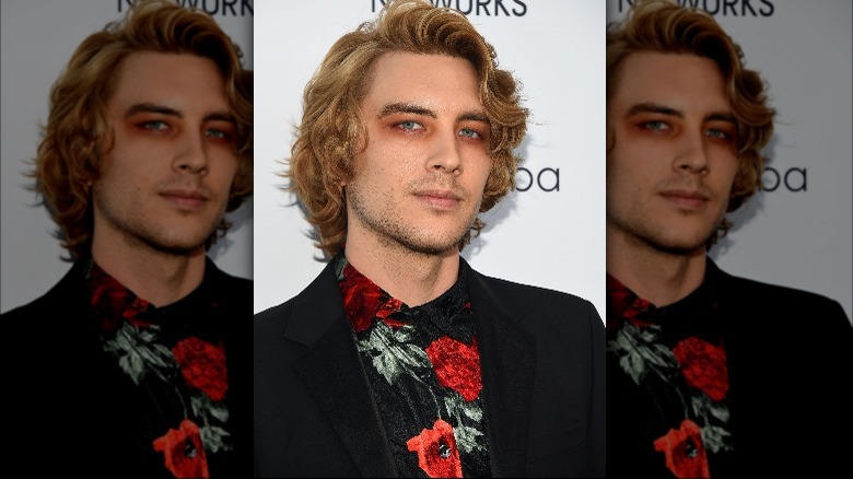 Cody Fern wearing red eyeshadow