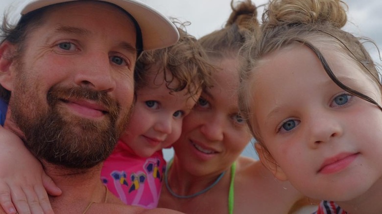 Christensen, her husband, and kids on the beach 