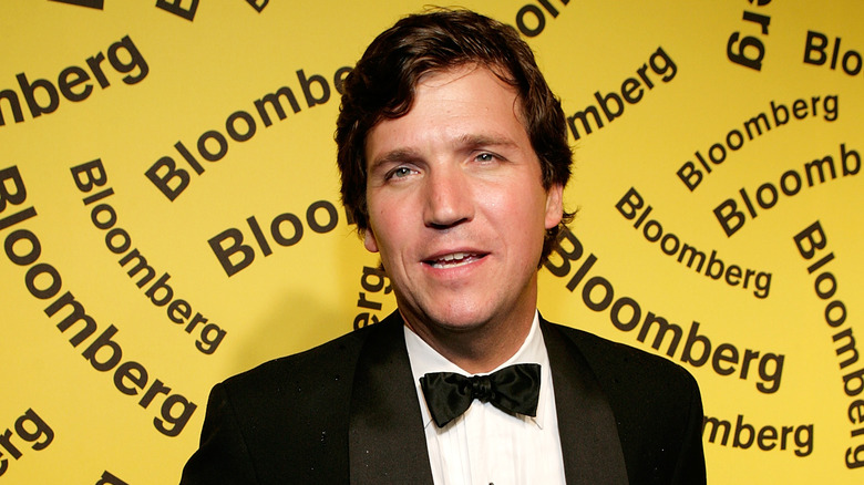 Tucker Carlson yellow Bloomberg background