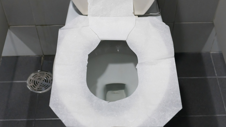 Toilet seat covered in paper