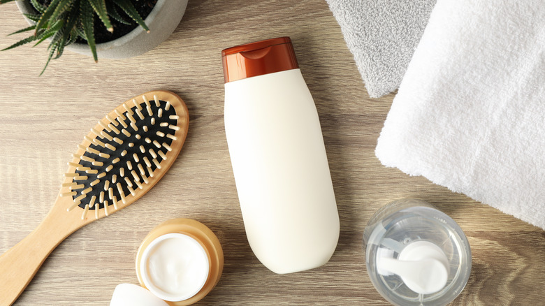 Hair products on wooden background 