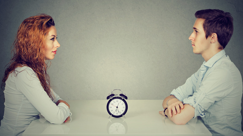 couple with a clock ticking between them