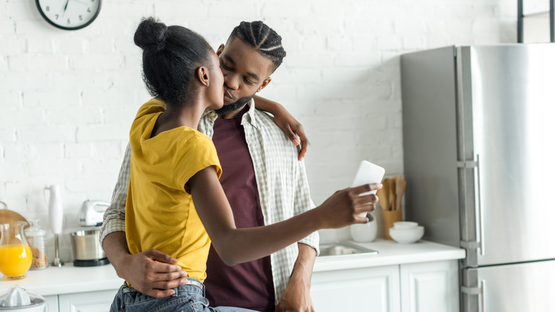 couple taking a selfie of themselves kissing