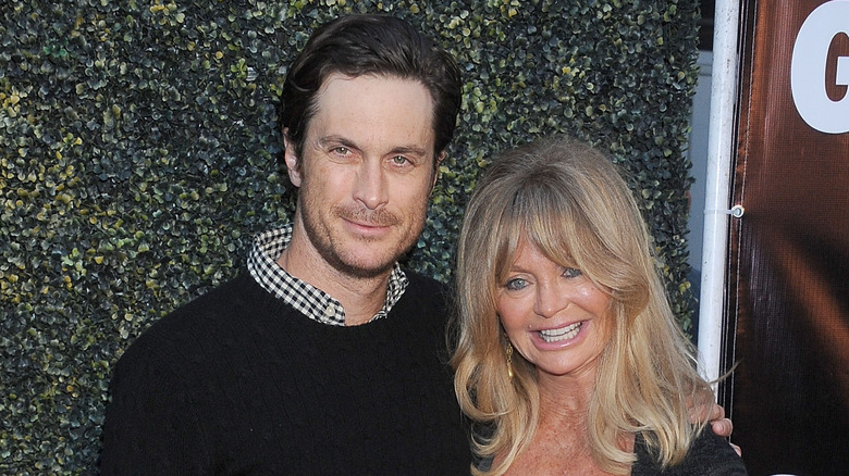 Oliver Hudson and Goldie Hawn posing at an event